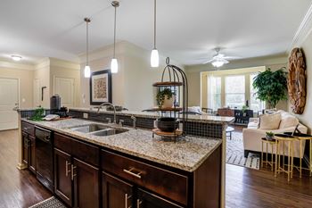A kitchen with an island and a living room with a couch